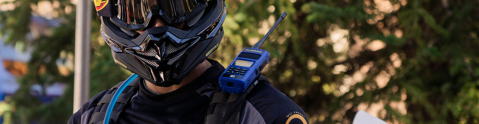 Durable business-band handheld radios (VHF/UHF) with long-range antenna, spare batteries, and speaker mic