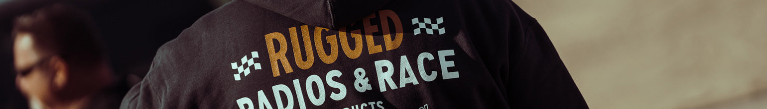 Rugged Radios Collection apparel—durable T‑shirts, hoodies, hats, beanies, crew socks, zip‑ups, and sunhats designed for off‑road style and comfort